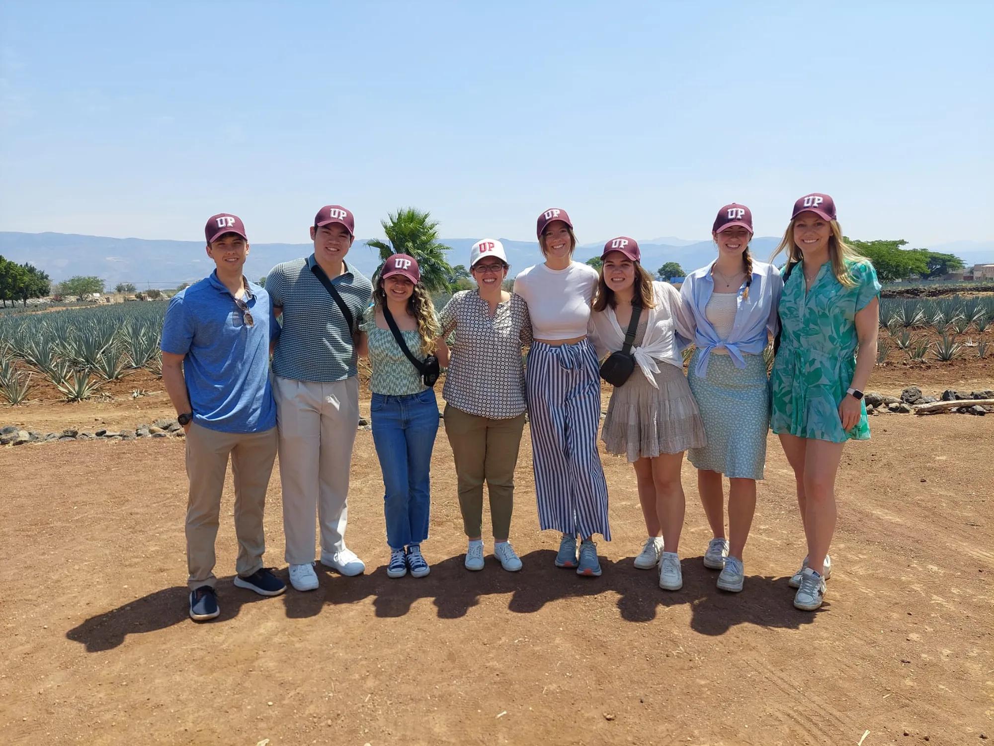 8 Students in the Business Honors Program from Guadalajara trip 2024 with Mentor Program Manager Helen Keefe.