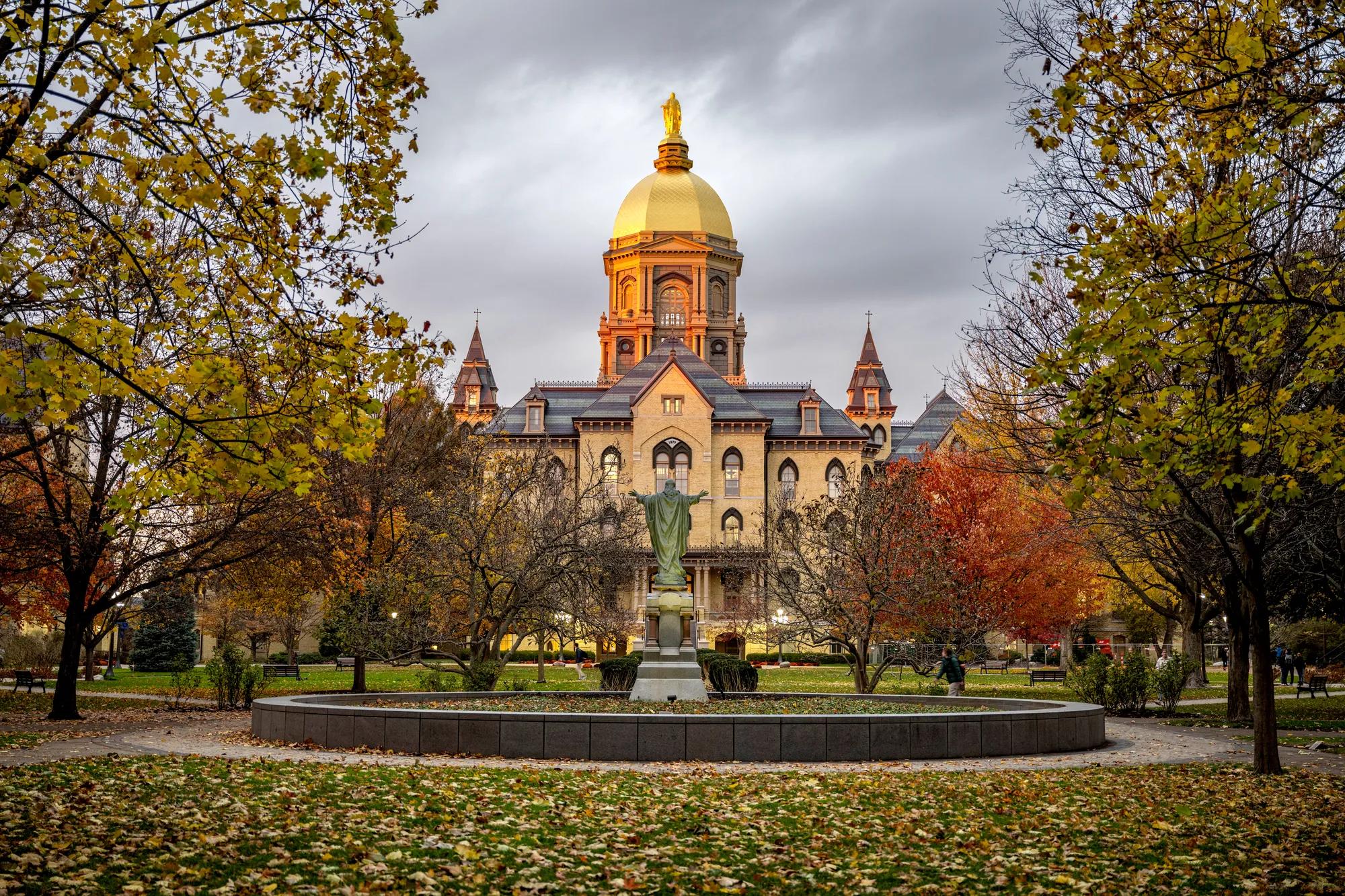 November 8, 2023; The Golden Dome and Statue of Mary atop the Main Building glow at sunset, autumn 2023. (Photo by Barbara Johnston/University of Notre Dame)