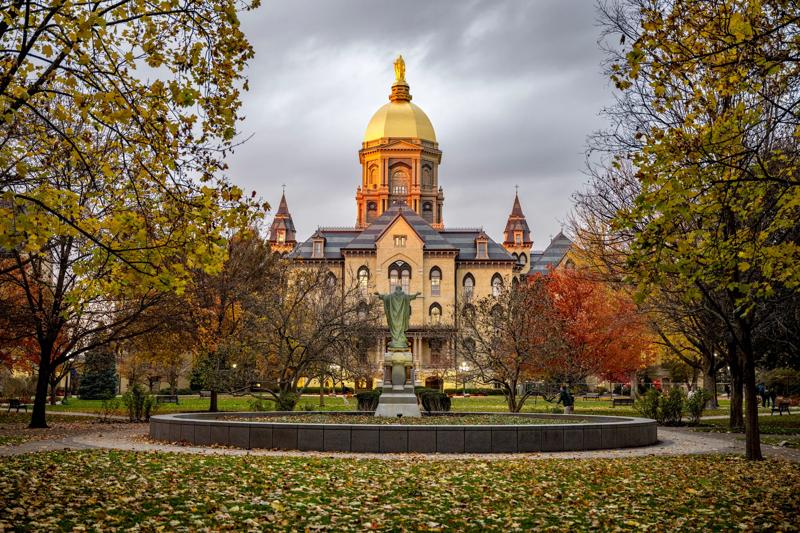 November 8, 2023; The Golden Dome and Statue of Mary atop the Main Building glow at sunset, autumn 2023. (Photo by Barbara Johnston/University of Notre Dame)