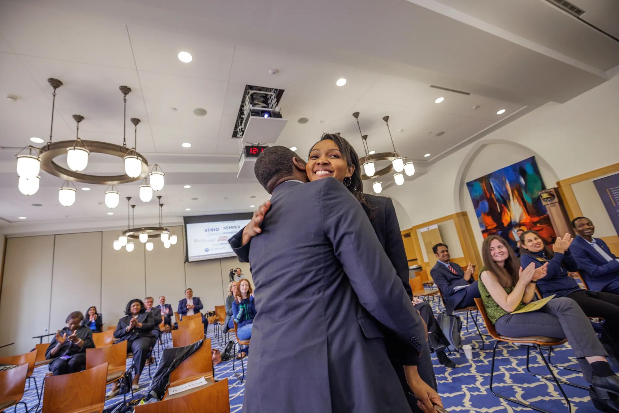 The winning team of one male and one female student hug after being announced as the winners while the audience applauds. | Photo by Peter Ringenberg/University of Notre Dame